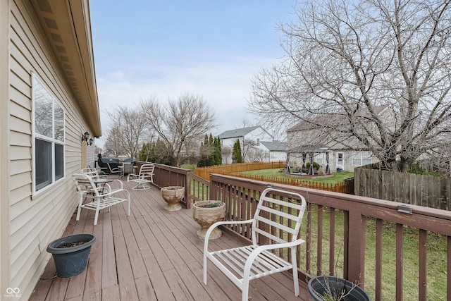 wooden deck with a lawn