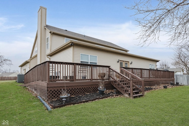 rear view of house featuring a lawn, a wooden deck, and cooling unit