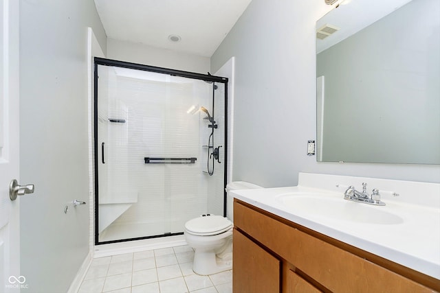 bathroom with toilet, vanity, tile patterned floors, and walk in shower