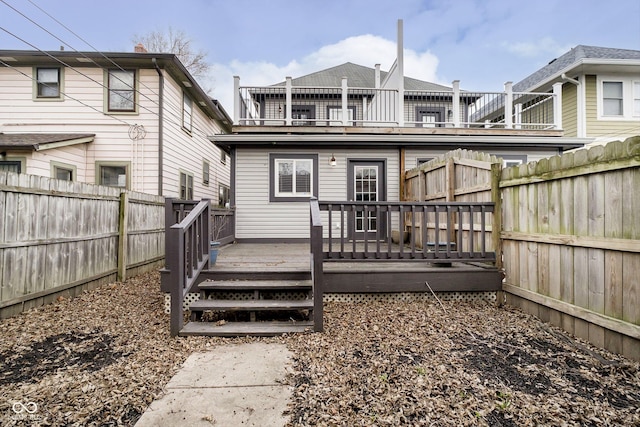 rear view of property featuring a wooden deck