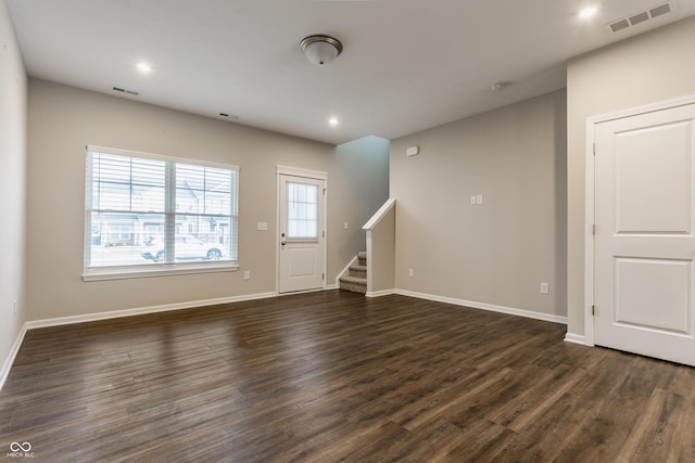 unfurnished living room featuring dark hardwood / wood-style flooring