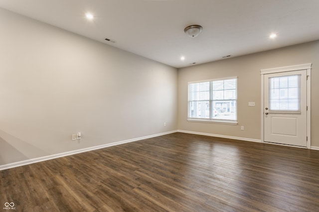 spare room with dark hardwood / wood-style flooring