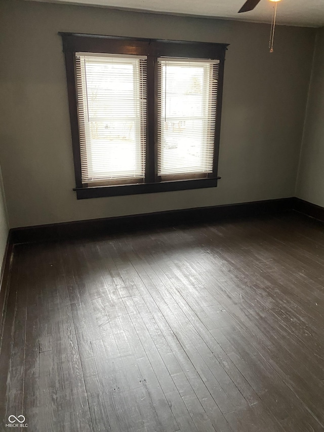 unfurnished room featuring ceiling fan and dark hardwood / wood-style floors