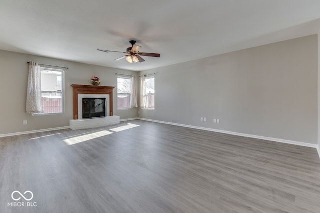 unfurnished living room with ceiling fan and hardwood / wood-style floors