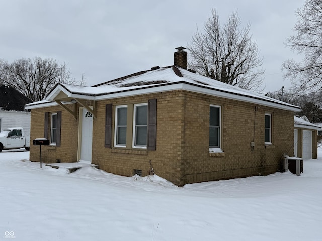 view of snowy exterior featuring central AC