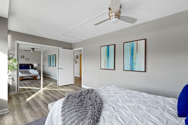 bedroom featuring hardwood / wood-style flooring, a closet, and ceiling fan