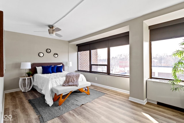 bedroom featuring ceiling fan and light hardwood / wood-style flooring