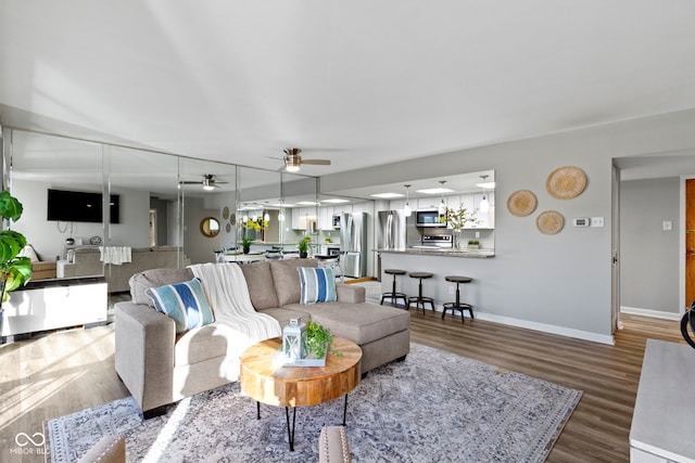 living room with ceiling fan and hardwood / wood-style floors