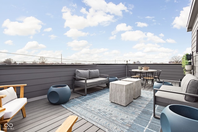 wooden terrace with an outdoor hangout area