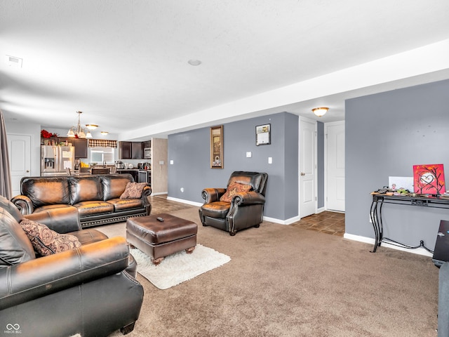 living room featuring carpet and a notable chandelier