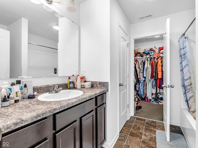 bathroom featuring shower / bath combo and vanity