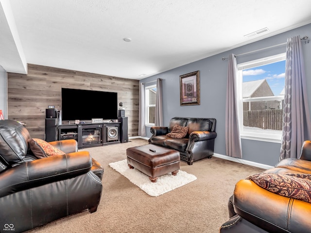 living room featuring wood walls and carpet