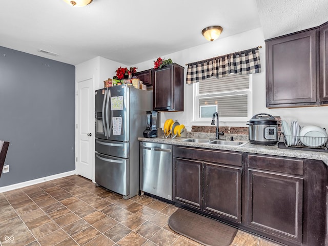 kitchen featuring sink, dark brown cabinetry, and stainless steel appliances