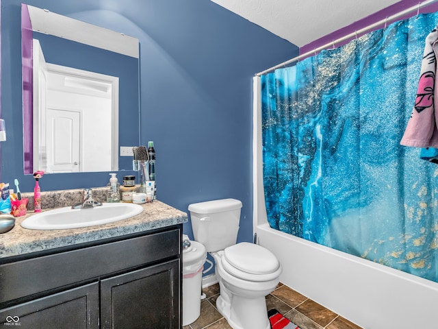 full bathroom featuring tile patterned flooring, vanity, toilet, and shower / bath combo with shower curtain