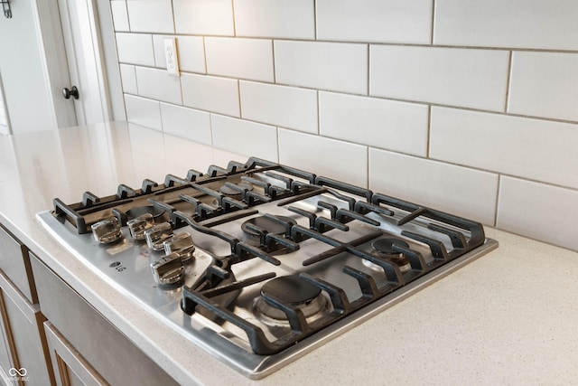 details with backsplash and stainless steel gas stovetop