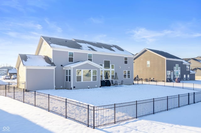 view of snow covered rear of property