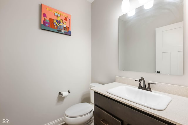 bathroom with toilet and vanity