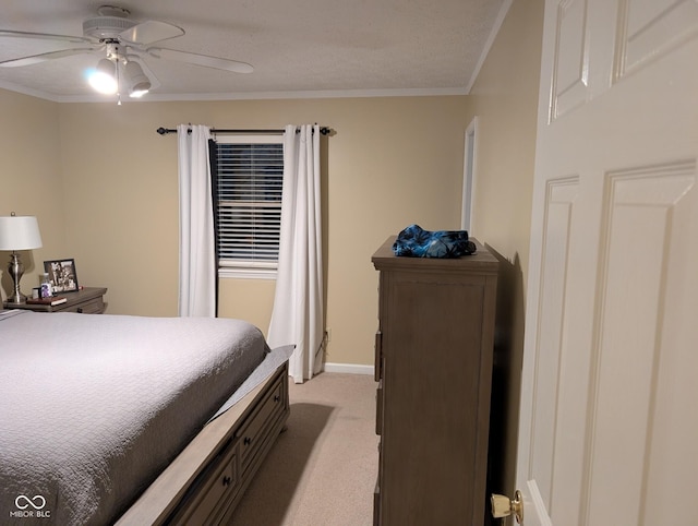 bedroom featuring ceiling fan, crown molding, light carpet, and a textured ceiling