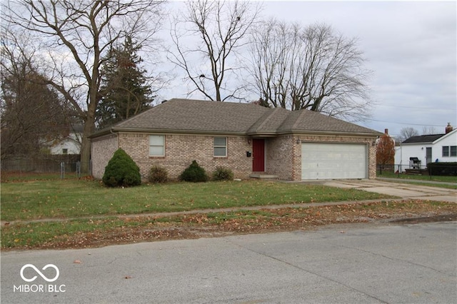 view of front of property with a front yard and a garage