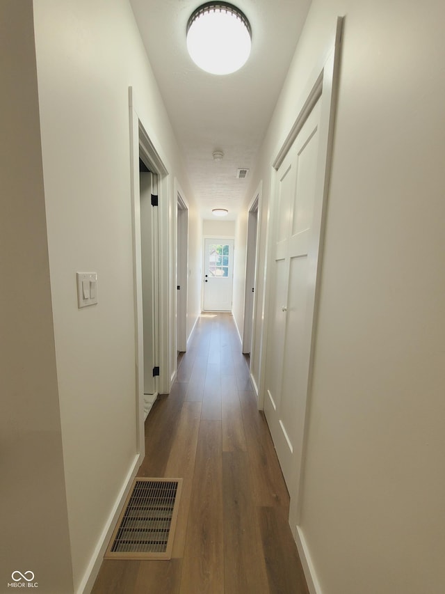 corridor featuring dark hardwood / wood-style floors