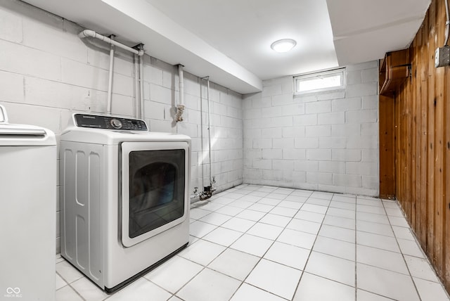 laundry room with washing machine and dryer and light tile patterned floors