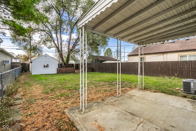 view of yard with central air condition unit, a patio area, and a storage unit