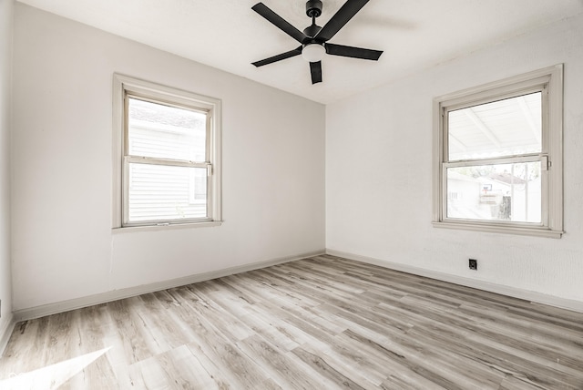 empty room with ceiling fan and light wood-type flooring