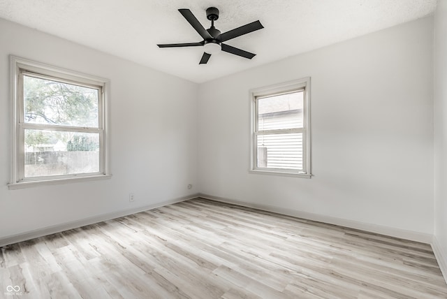 spare room with ceiling fan and light hardwood / wood-style floors