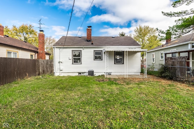 back of property with a yard and central air condition unit