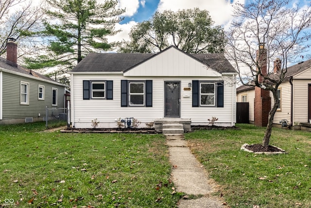 bungalow-style home with a front lawn