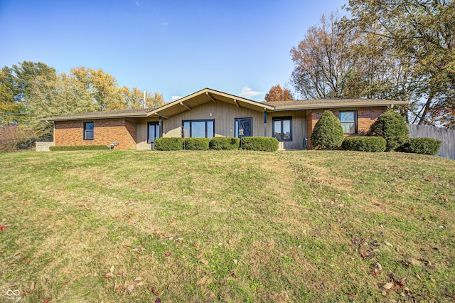 ranch-style home with a front lawn