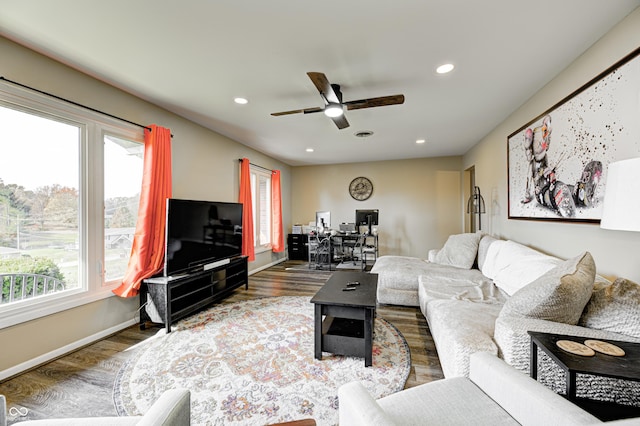 living room with wood-type flooring and ceiling fan