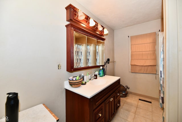 bathroom featuring tile patterned flooring and vanity