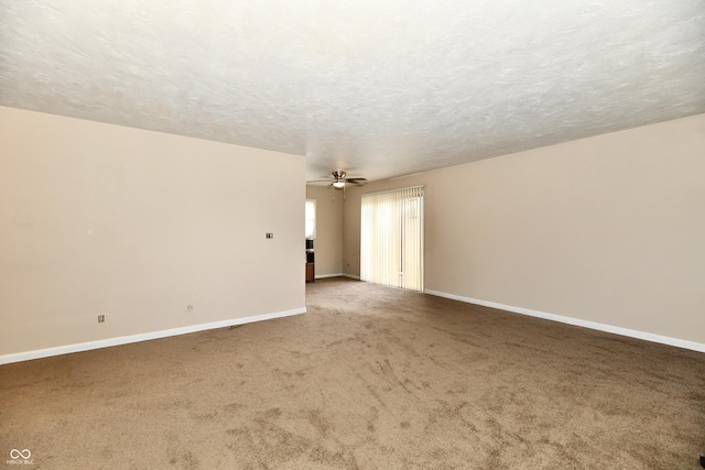 empty room featuring carpet flooring, a textured ceiling, and ceiling fan