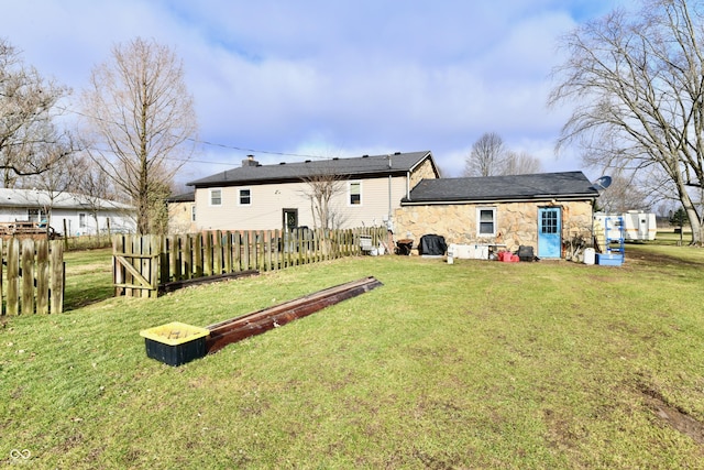 rear view of property featuring a yard