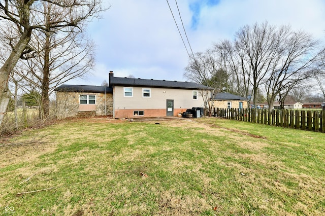 back of house with a lawn