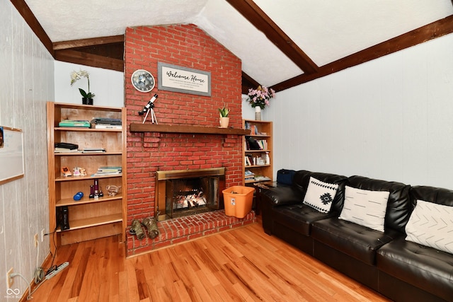 living room featuring hardwood / wood-style flooring, vaulted ceiling with beams, wood walls, and a brick fireplace