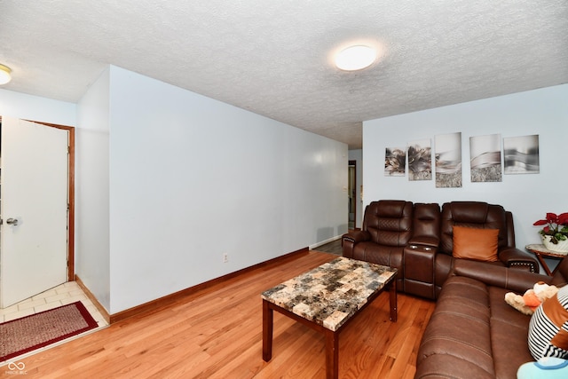 living room featuring hardwood / wood-style flooring and a textured ceiling