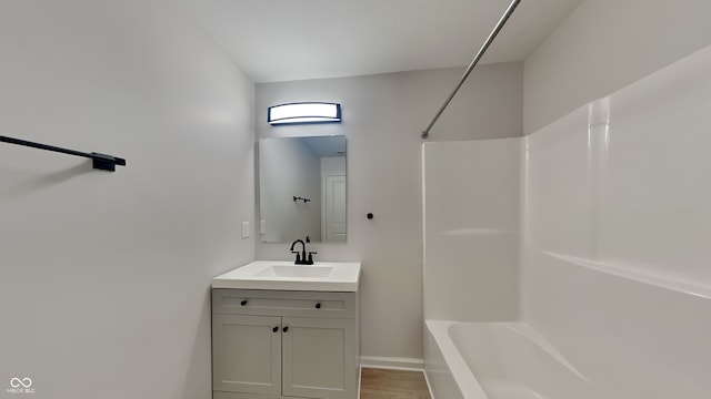 bathroom featuring vanity, wood-type flooring, and shower / washtub combination