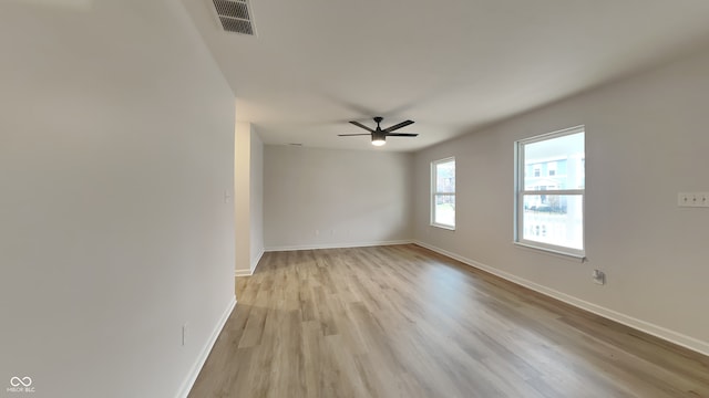 empty room featuring ceiling fan and light wood-type flooring