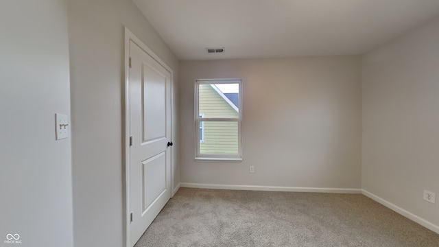 empty room with light colored carpet