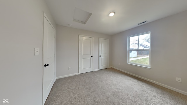 unfurnished bedroom featuring light carpet