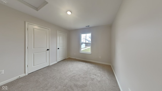 unfurnished bedroom with light colored carpet