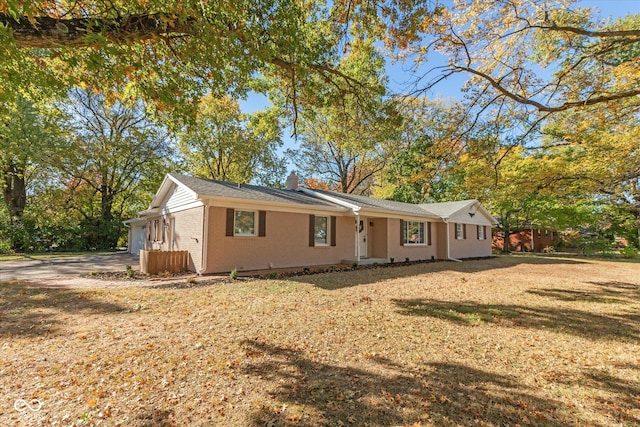 ranch-style home featuring a front yard