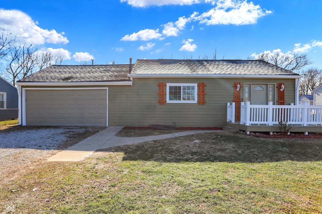 ranch-style house with a wooden deck, a front yard, and a garage