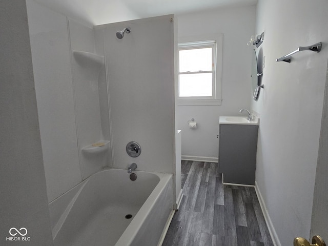 bathroom featuring shower / bathing tub combination, hardwood / wood-style floors, and vanity