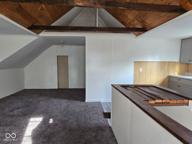 bonus room featuring carpet, vaulted ceiling with beams, and wooden ceiling