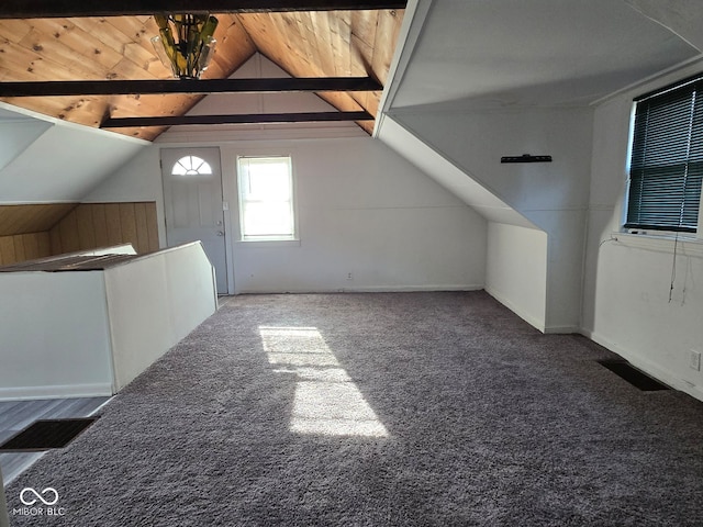 bonus room featuring vaulted ceiling with beams, dark carpet, and wood ceiling