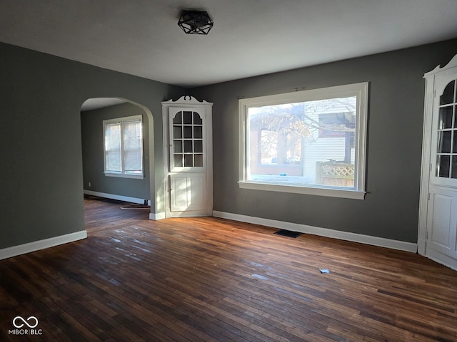 unfurnished dining area featuring dark hardwood / wood-style flooring