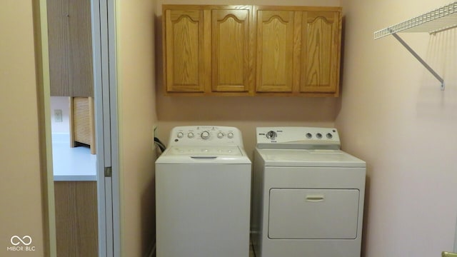 laundry area featuring cabinets and washer and dryer